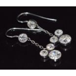 A pair of Art Deco platinum earrings, each set with transitional cut diamonds of approximately 0.