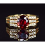 An 18ct gold ring set with a oval cut ruby of approximately 1.4ct and diamonds, 5g, size N