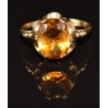 A 9ct gold ring set with an oval cut citrine, 2.2g, size O