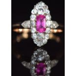 A late Victorian ring set with a pink sapphire surrounded by old cut diamonds, and with rose cut