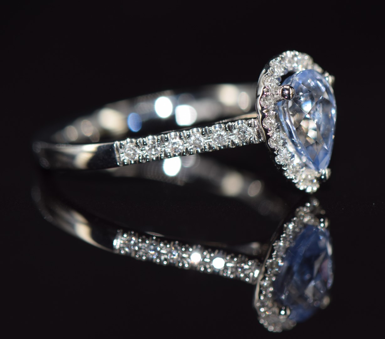 A platinum ring set with a pear cut Sri Lankan sapphire of approximately 1.25ct surrounded by - Image 2 of 2