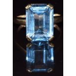 A 9ct gold ring set with an emerald cut blue topaz, 5.9g, size I