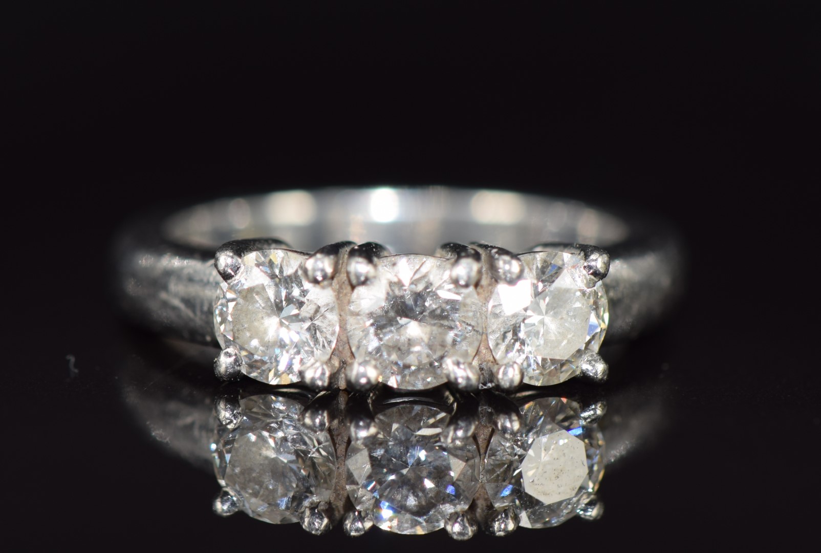 A platinum ring set with three round cut diamonds, each approximately 0.35ct, 6.8g, size J