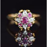 An 18ct gold ring set with rubies and diamonds in a cluster, 4.4g, size O