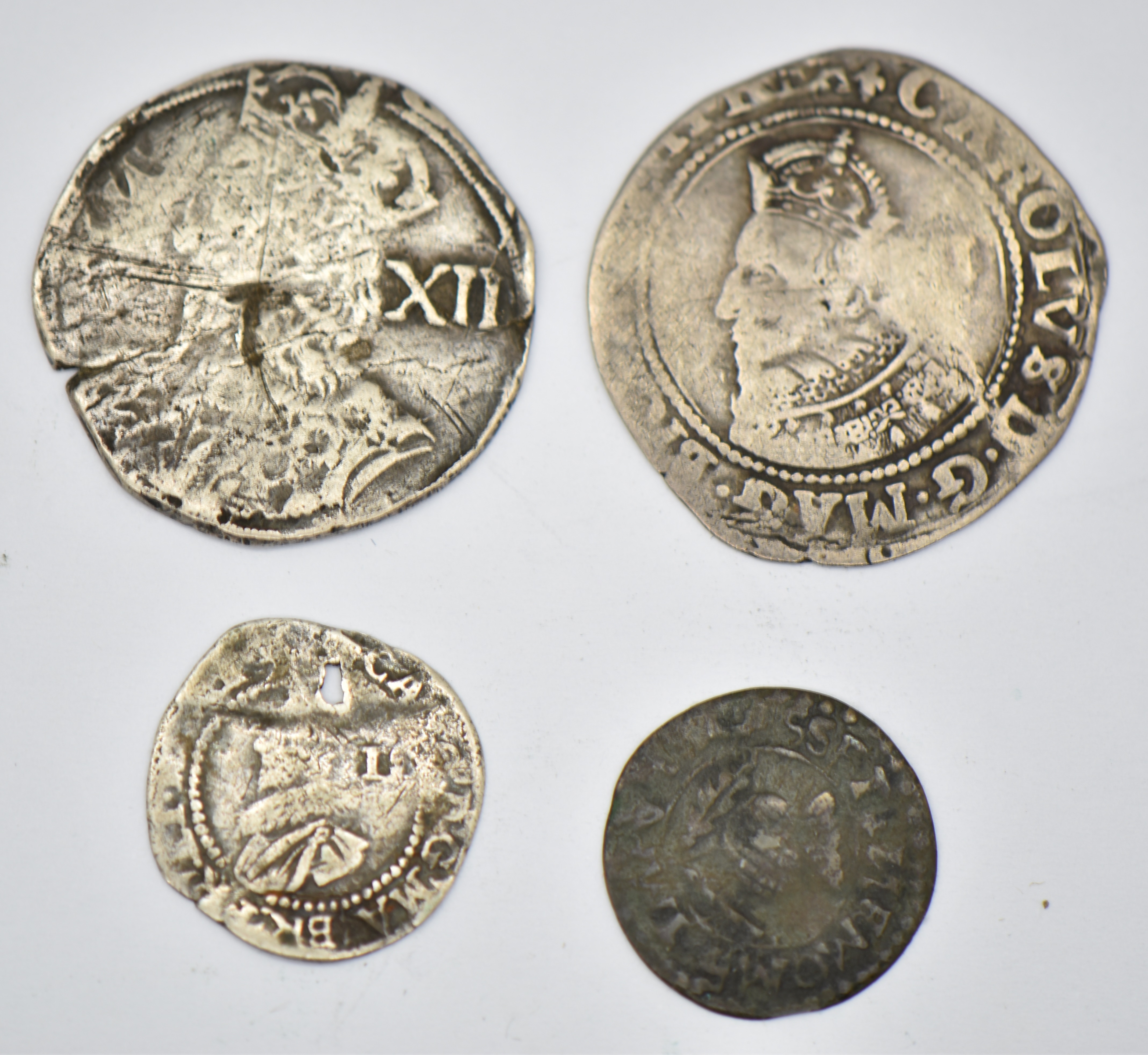 Four Charles I coins comprising a 1625 hammered sixpence, heavily clipped shilling with bust and