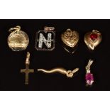 Six 9ct gold pendants including ruby and diamond, hearts, cross and letter N (2.4g) and 14k gold