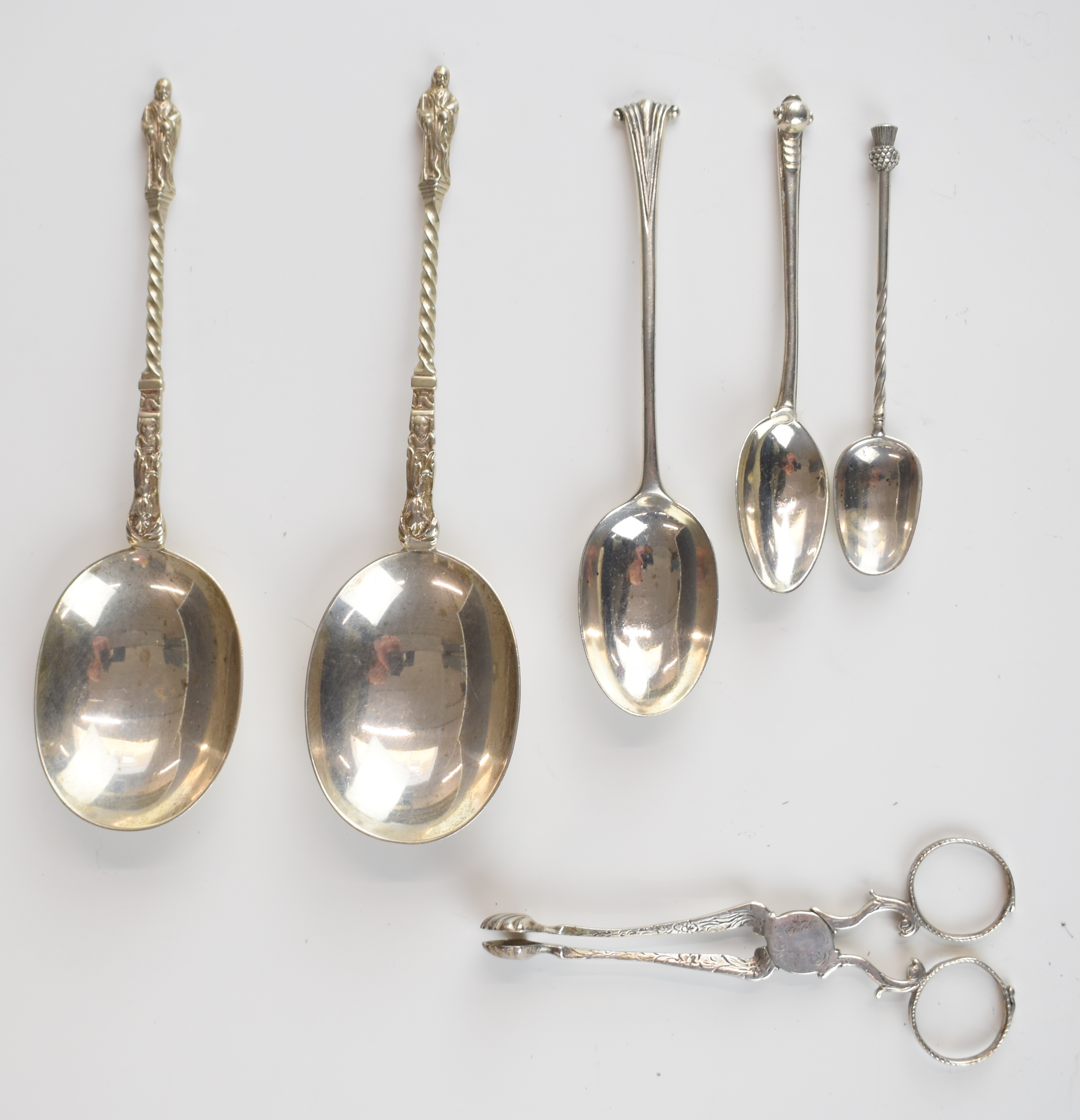Georgian and later hallmarked silver cutlery including sugar nips and a pair of apostle or similar