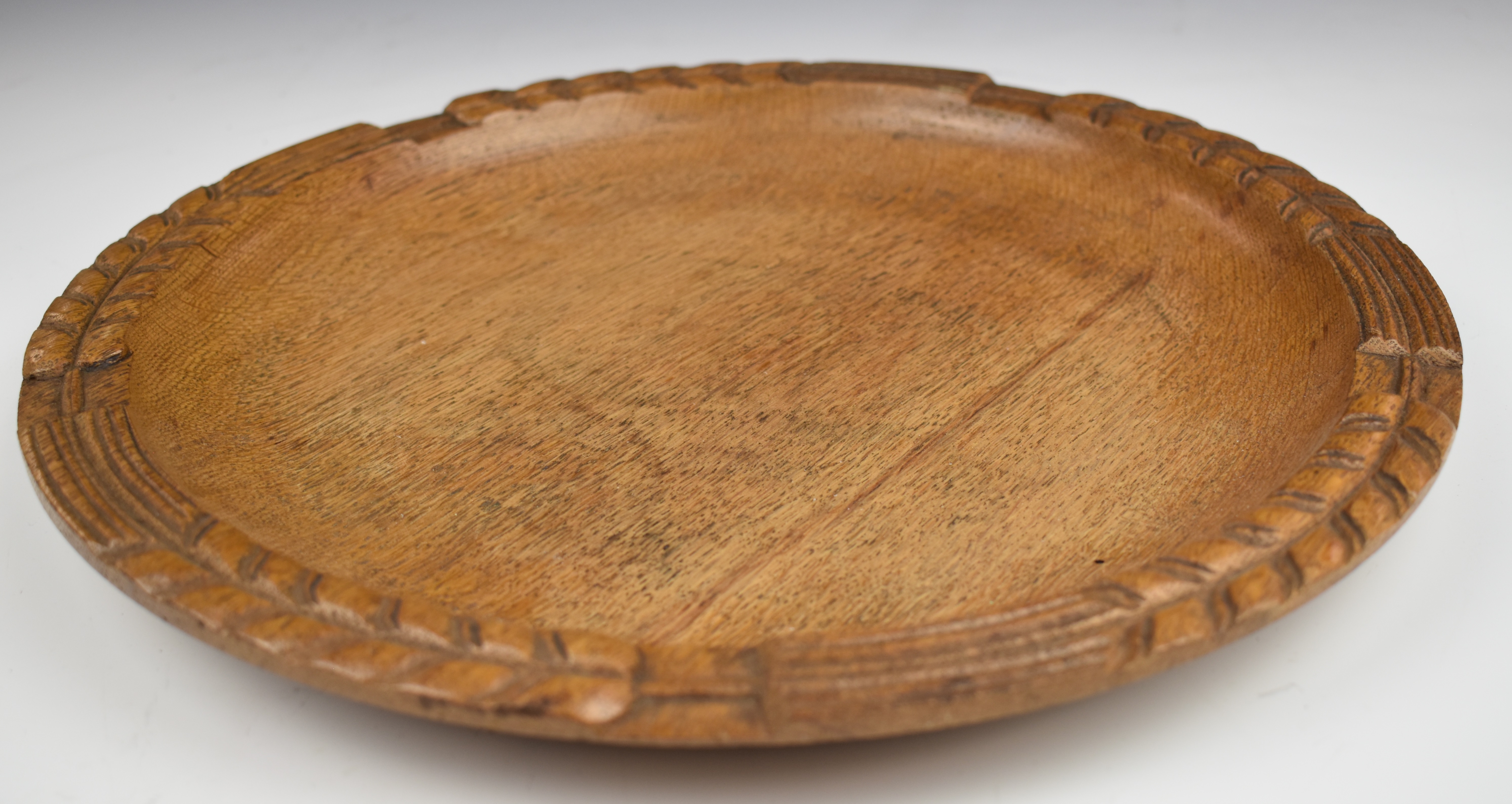 Cotswold School carved oak bread tray or platter, diameter 36cm