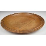 Cotswold School carved oak bread tray or platter, diameter 36cm