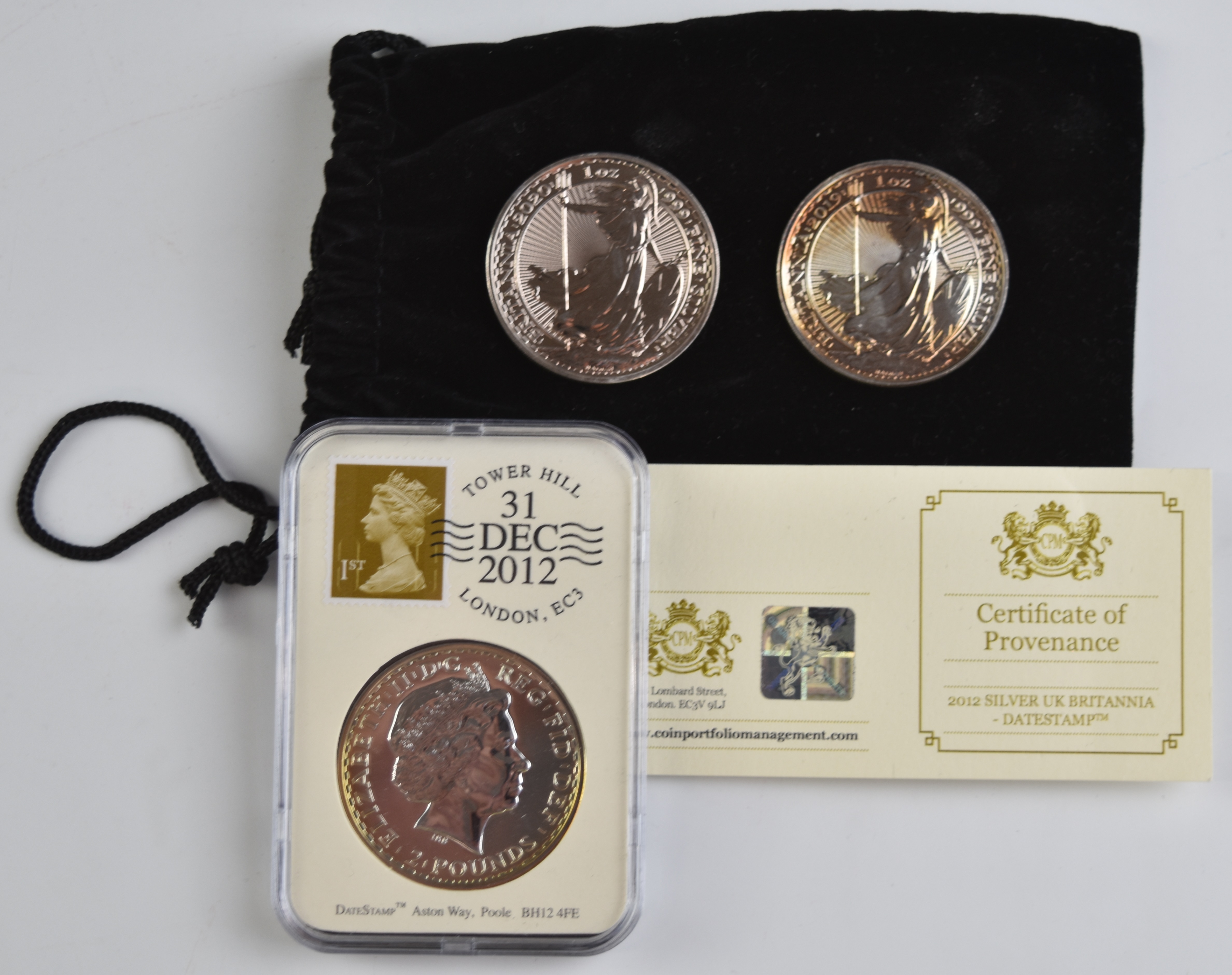 Three silver UK Britannia coins comprising two 1999 and a slabbed 2012 example with certificate