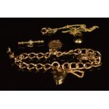 A 9ct gold charm bracelet with three 9ct gold charms including pig, 'good luck' and dolphin, 9ct