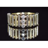A 14ct gold bi-coloured ring set with three diamonds, 9.7g, size T