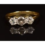An 18ct gold ring set with three diamonds totalling approximately 0.65ct, in antique box