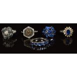 Five silver rings set with diamonds and sapphires