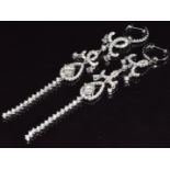 A pair of 18ct white gold earrings set with a diamond of approximately 0.4ct and a quantity of