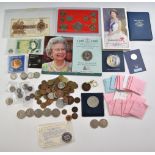 A tin containing a collection of various coins and coin sets, small silver content, George V £1 note