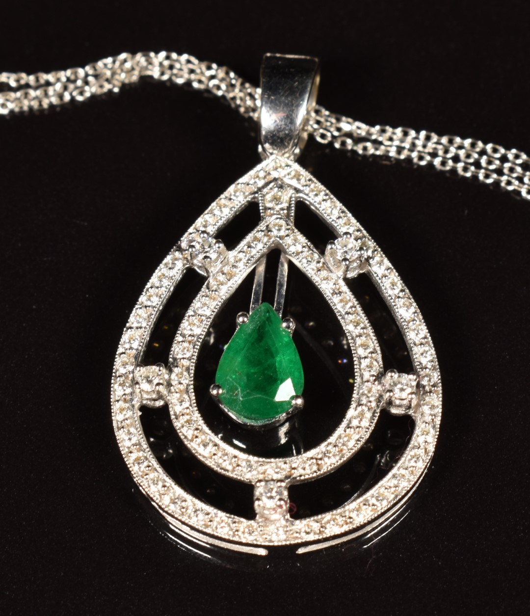 A 18k white gold pendant set with a pear cut emerald of approximately 0.8ct surrounded by - Image 2 of 4