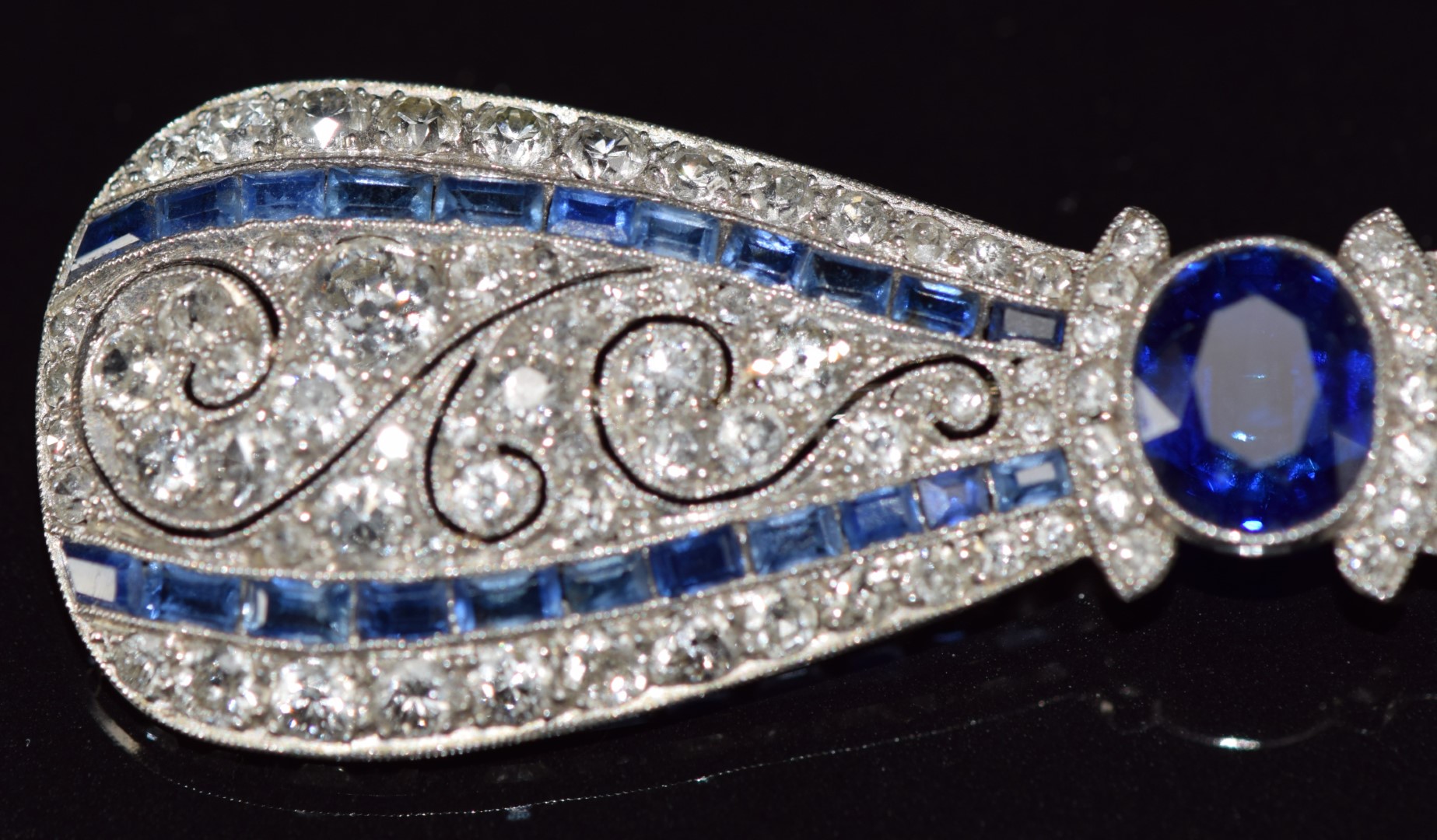 A c1915 platinum brooch in the form of a bow set with an oval cut sapphire measuring approximately - Image 6 of 7