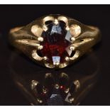 A 9ct gold ring set with an oval cut garnet, 2.2g, size R