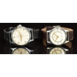 Two Smiths de Luxe gentleman's wristwatches, each with gold hands and Arabic numerals, cream dial