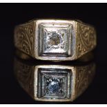 A 9ct gold ring set with a diamond of approximately 0.25ct with engraved decoration to the