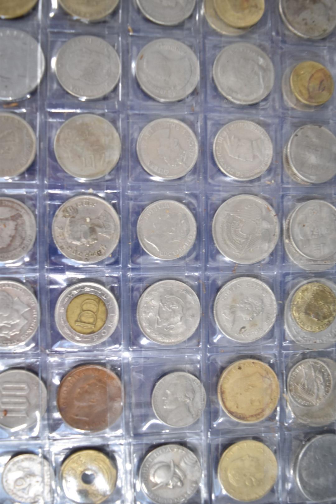 A collection of world coins contained in a Change Checker album - Bild 2 aus 6