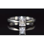 A platinum ring set with an 0.4ct emerald cut diamond, with paperwork from Beaverbrooks, 3.9g,