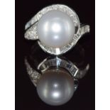 An 18ct white gold ring set with a 15.11ct South Sea pearl surrounded by round and baguette cut