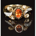 A 9ct gold ring set with an oval cut garnet and diamonds, 3.1g, size N