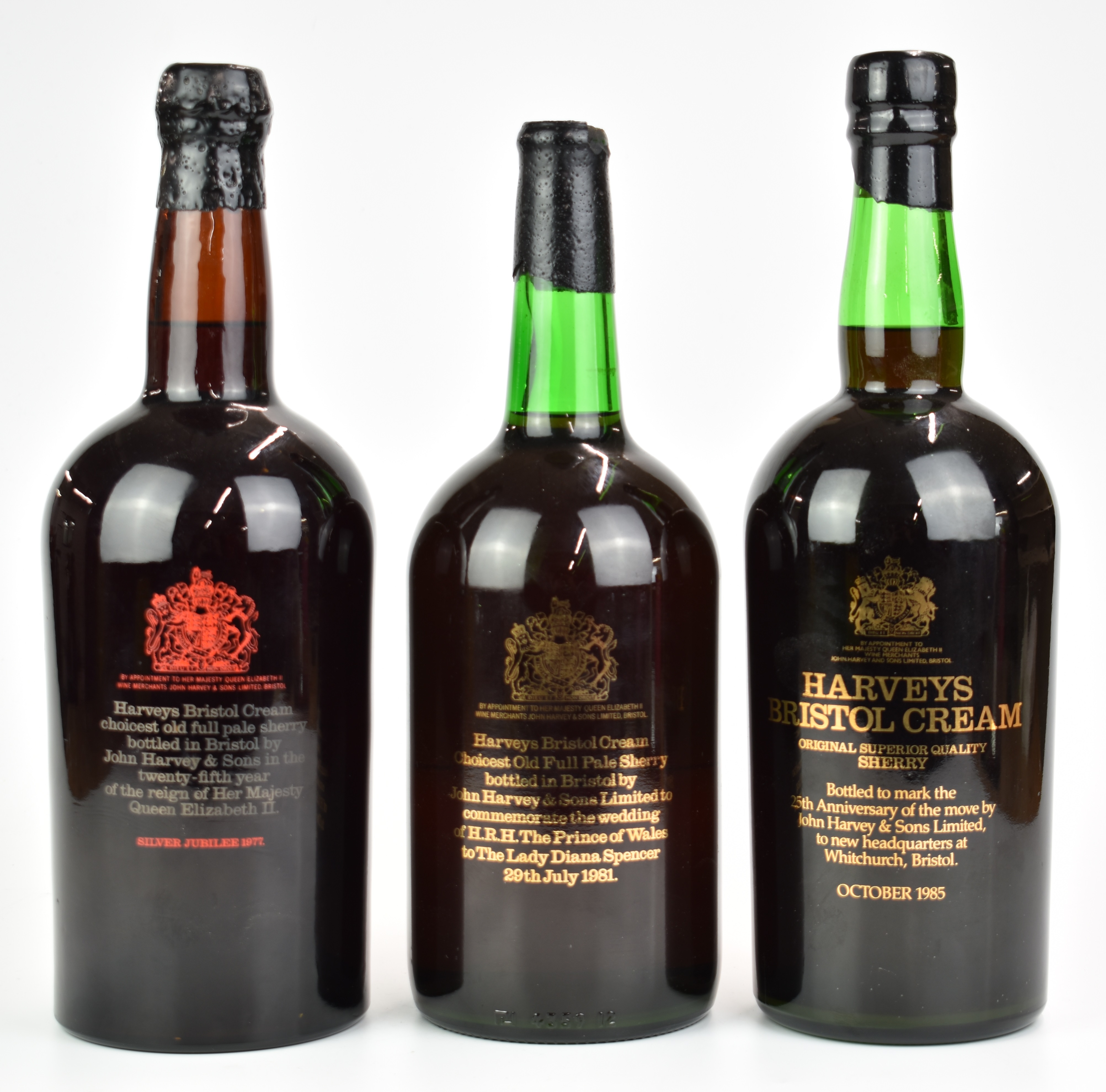 Three oversized bottles of Harvey's Bristol Cream Sherry commemorating Royal events and moving