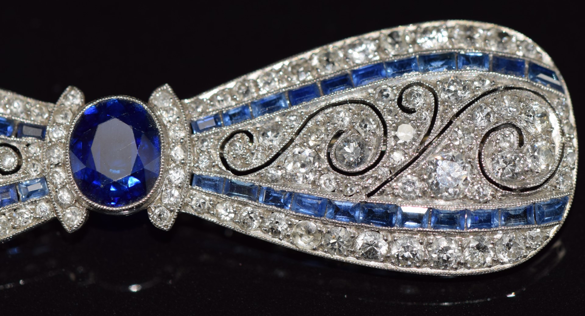 A c1915 platinum brooch in the form of a bow set with an oval cut sapphire measuring approximately - Image 7 of 7