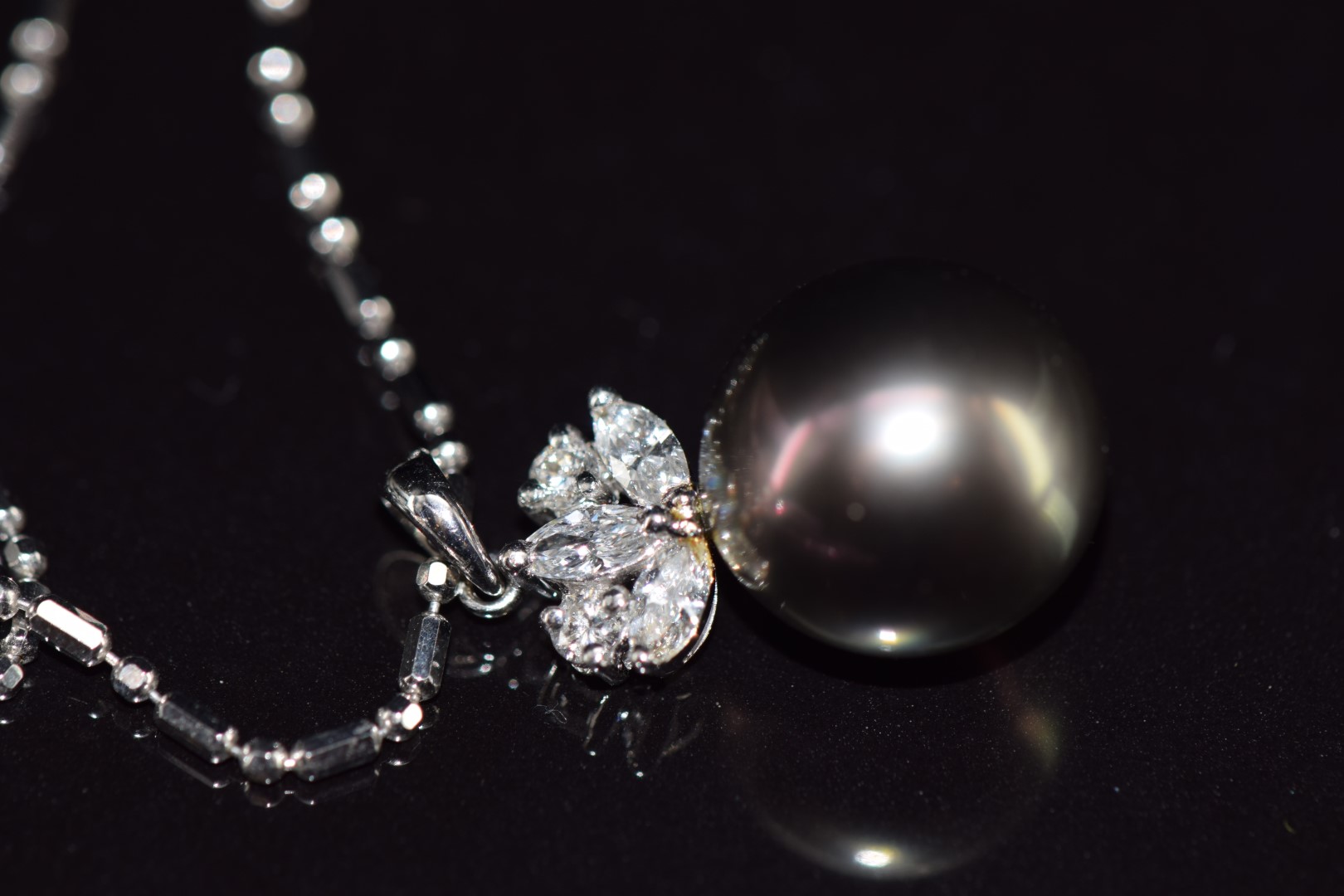 An 18ct white gold pendant set with a 13ct black South Sea pearl, three marquise cut diamonds and - Image 3 of 4