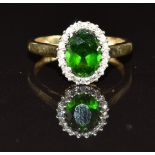 A 9ct gold ring set with an oval cut tourmaline surrounded by diamonds, 1.9g, size K