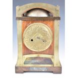 Oak and brass cased Arts & Crafts style mantel clock, with embossed dial, glass panel to base and