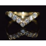 An 18ct gold V shape ring set with seven diamonds, each approximately 0.07ct, 2.6g, size J