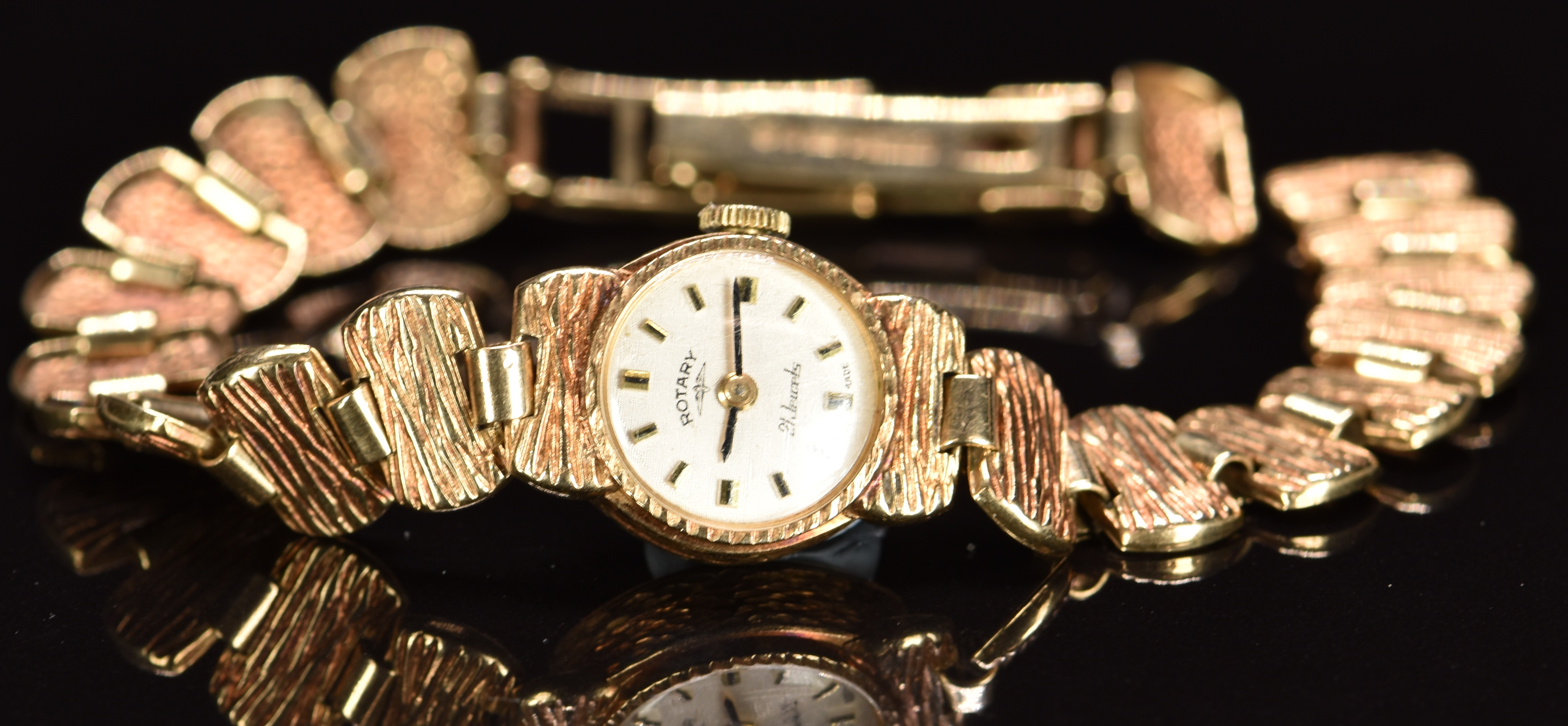 Rotary 9ct gold ladies wristwatch with black hands, two-tone hour markers, silver dial and 21