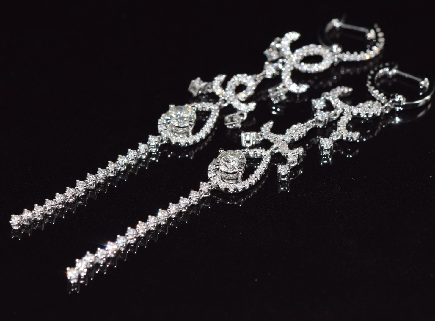 A pair of 18ct white gold earrings set with a diamond of approximately 0.4ct and a quantity of - Image 2 of 3