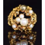 A 1970s 9ct gold ring set with pearls in a textured mount, Birmingham 1971, 9.2g, size M