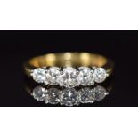 An 18ct gold ring set with five diamonds of approximately 0.3ct, 0.2ct, two 0.15ct, and 0.2ct, 5.0g,