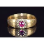 A c1910 18ct gold ring set with a ruby in a star setting, 3.9g, size M