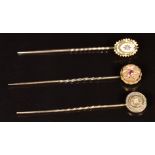 Three Victorian 15ct gold stick pins set with ruby and diamonds, 2.6g