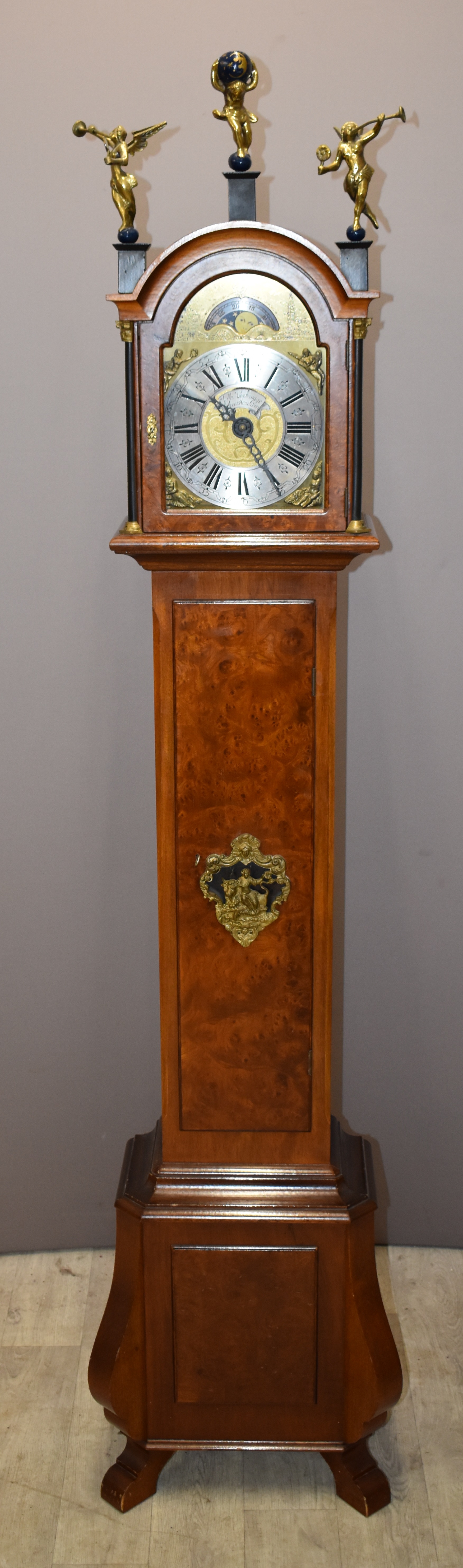 Walnut cased grandmother clock with figural decoration, moonphase, date and J M Verbrugge, Amsterdam