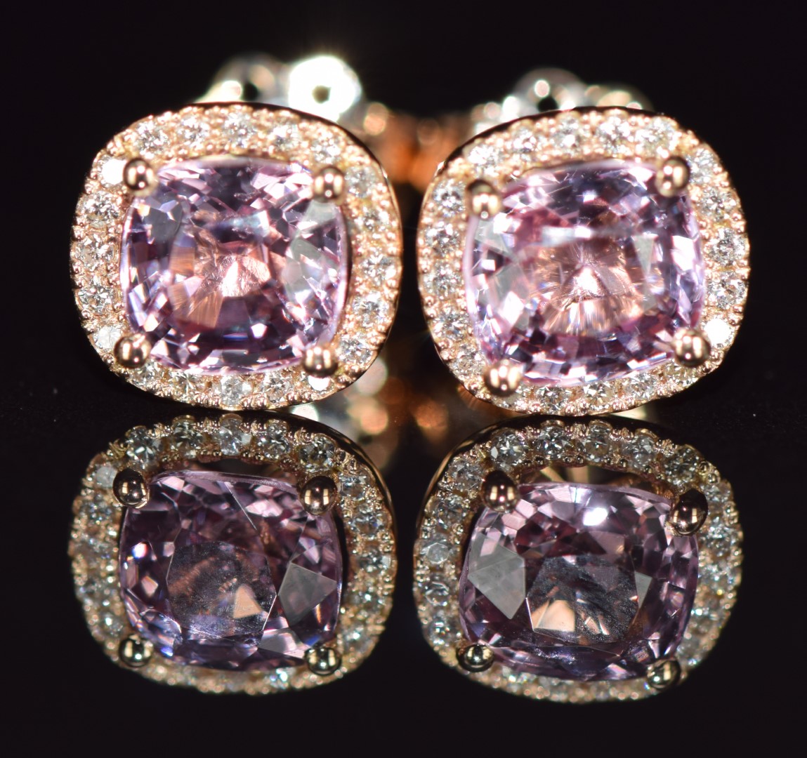 A pair of 18ct rose gold earrings each set with a 1.2ct pink sapphire surrounded by diamonds, 2.5g