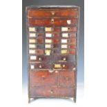 19th/20thC miniature / tabletop pine chest of 24 drawers full of mainly watch parts and tools