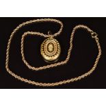 Victorian yellow metal locket with foliate decoration, on 9ct gold rope twist chain, 13.6g