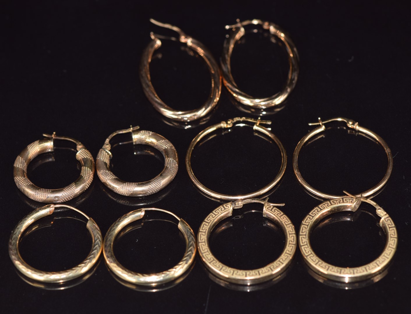 Five pairs of 9ct gold hoop earrings including Greek key design, twist and textured decoration, 9.2g