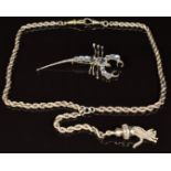 A silver necklace / fob chain with tassel charm and a brooch in the form of a scorpion set with