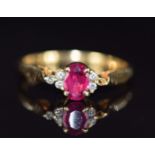 An 18ct gold ring set with an oval cut ruby and diamonds (one diamond missing), 2.7g, size N