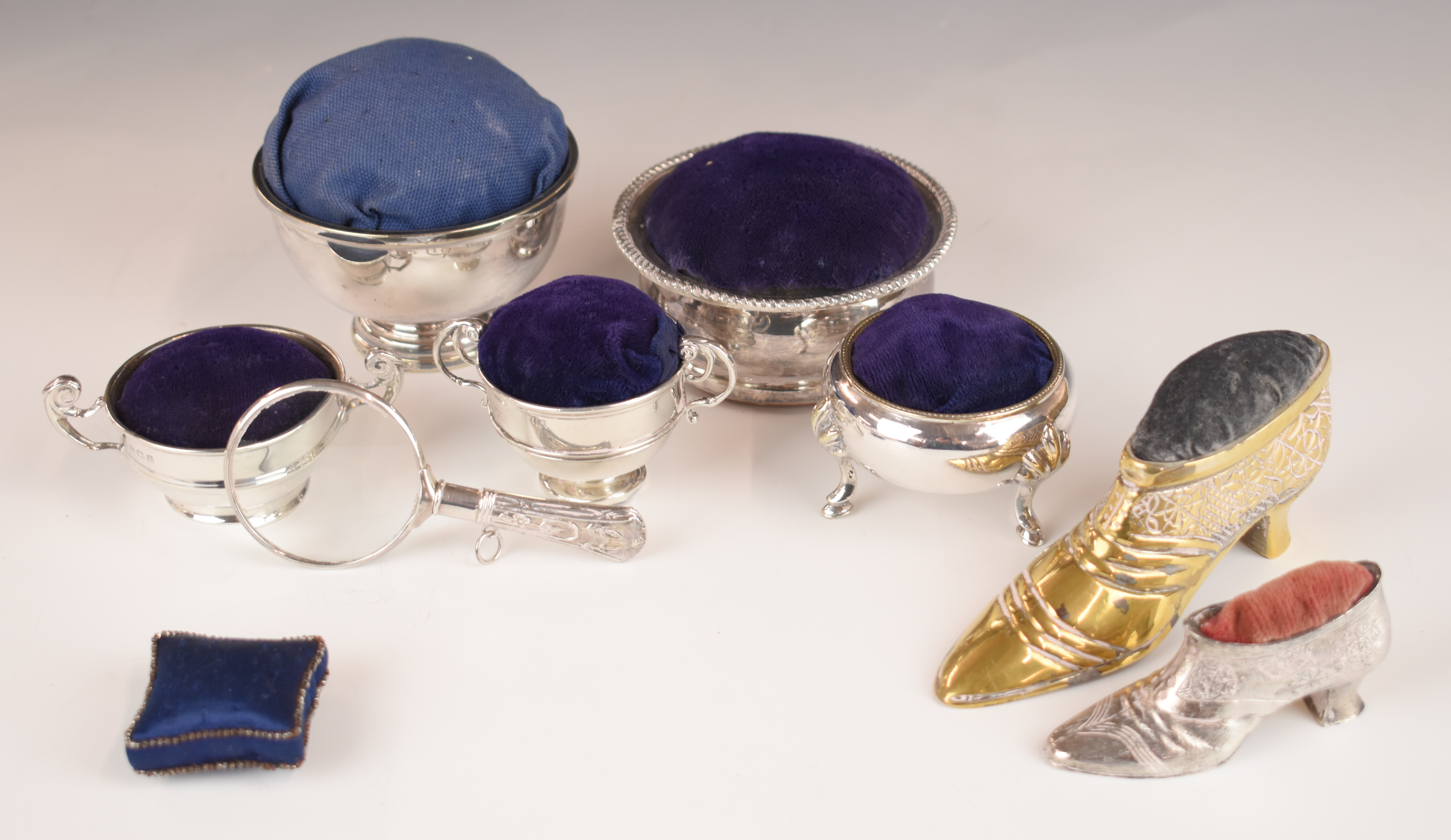 Eight various pin cushions, two using hallmarked silver twin handled cups, one with cut steel beaded