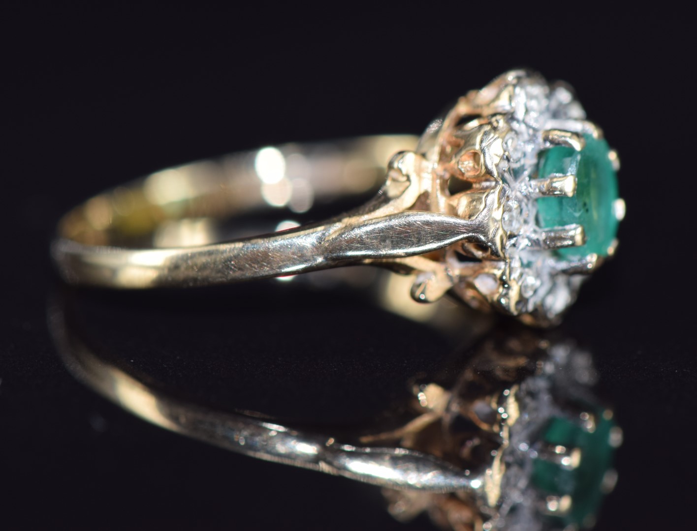 A 9ct gold ring set with an oval cut emerald surrounded by diamonds, 2g, size O - Image 2 of 2
